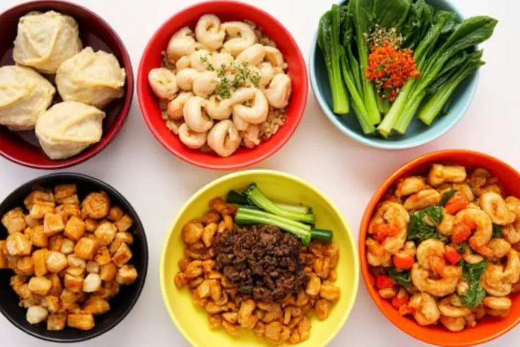Chopsticks picking up chicken and broccoli, a simple dish from this list of healthy Chinese recipes"